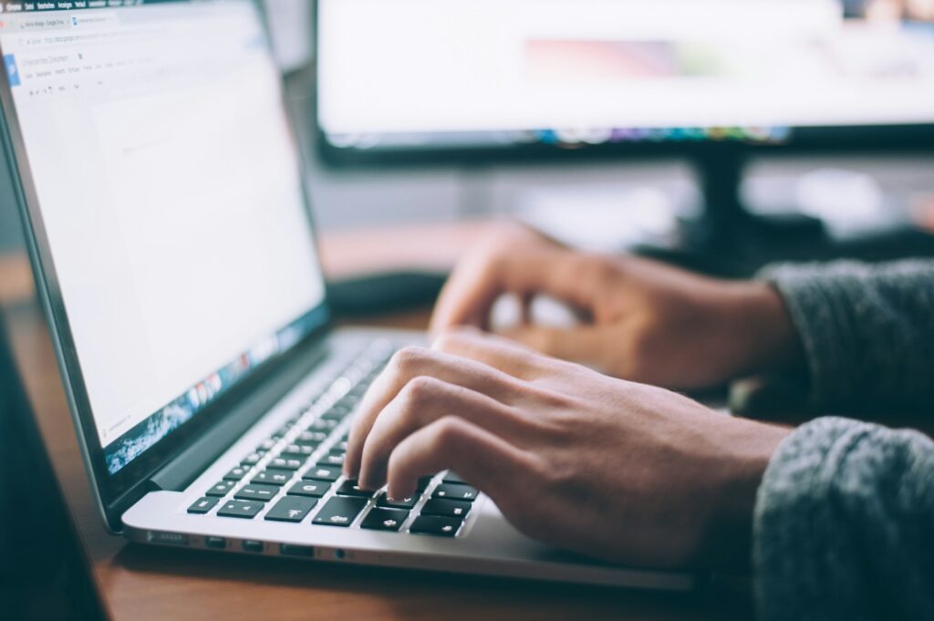 How to do Email Marketing - Writing high-converting campaign emails Person typing on a laptop laptop while drafting an email marketing strategy
